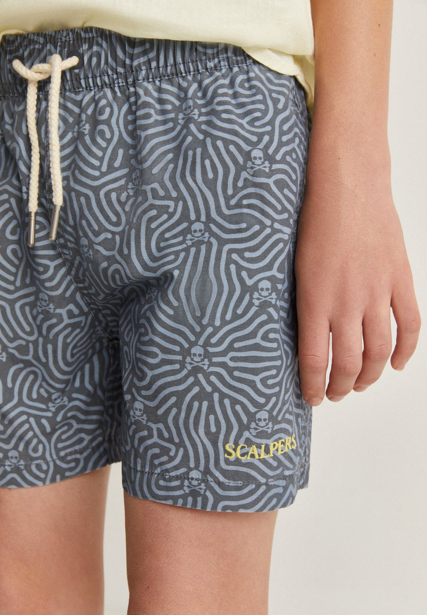 SWIMMING TRUNKS WITH ALL-OVER SKULLS DETAIL