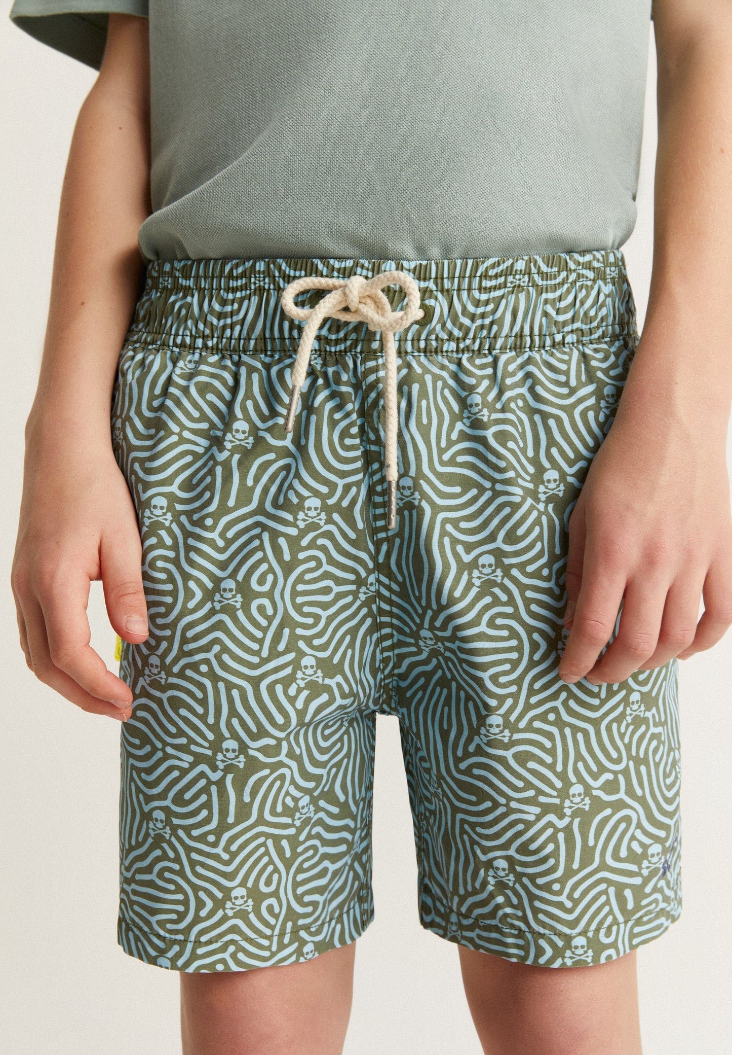 SWIMMING TRUNKS WITH ALL-OVER SKULLS DETAIL