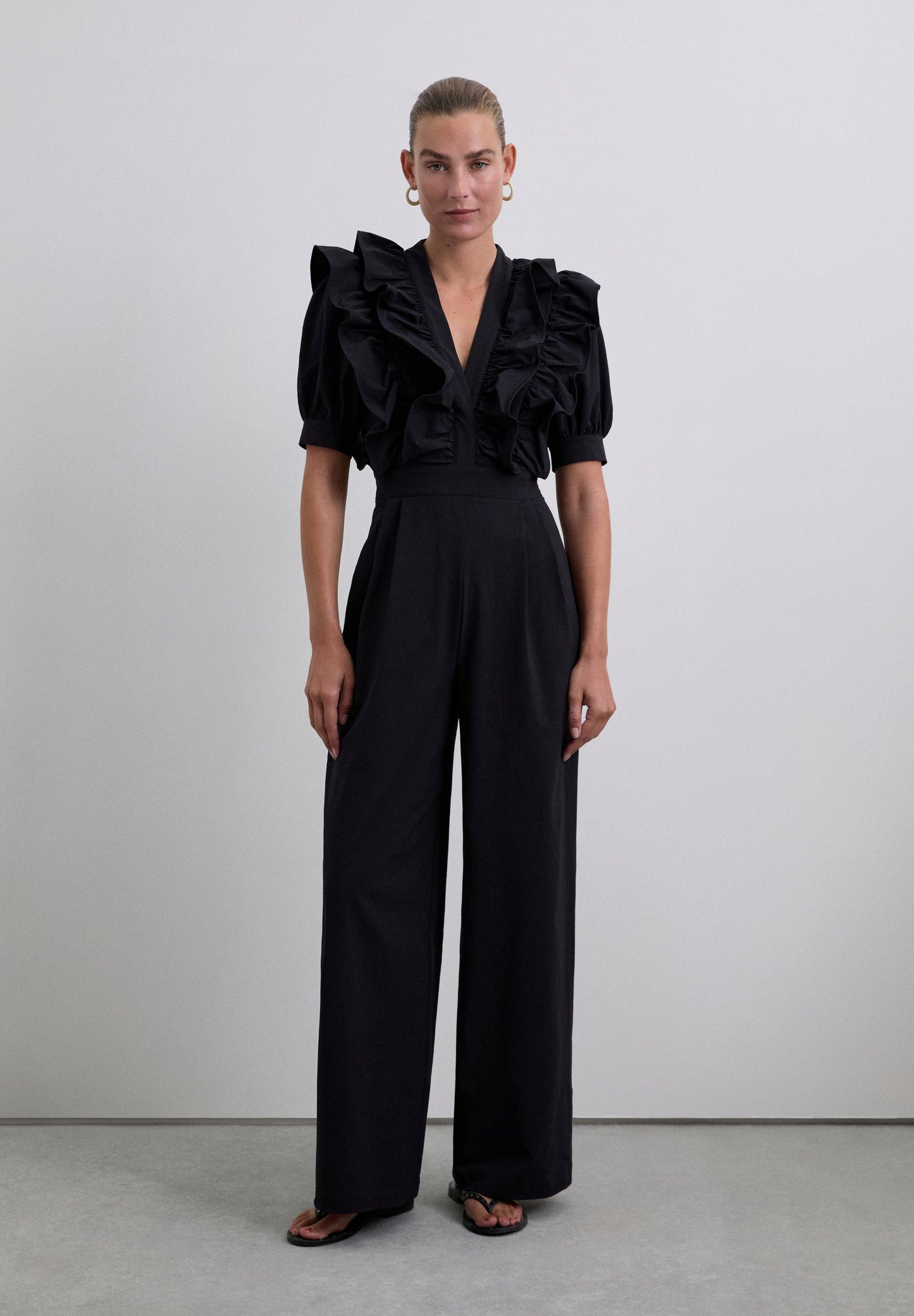 SCHWARZER JUMPSUIT MIT VOLANTS