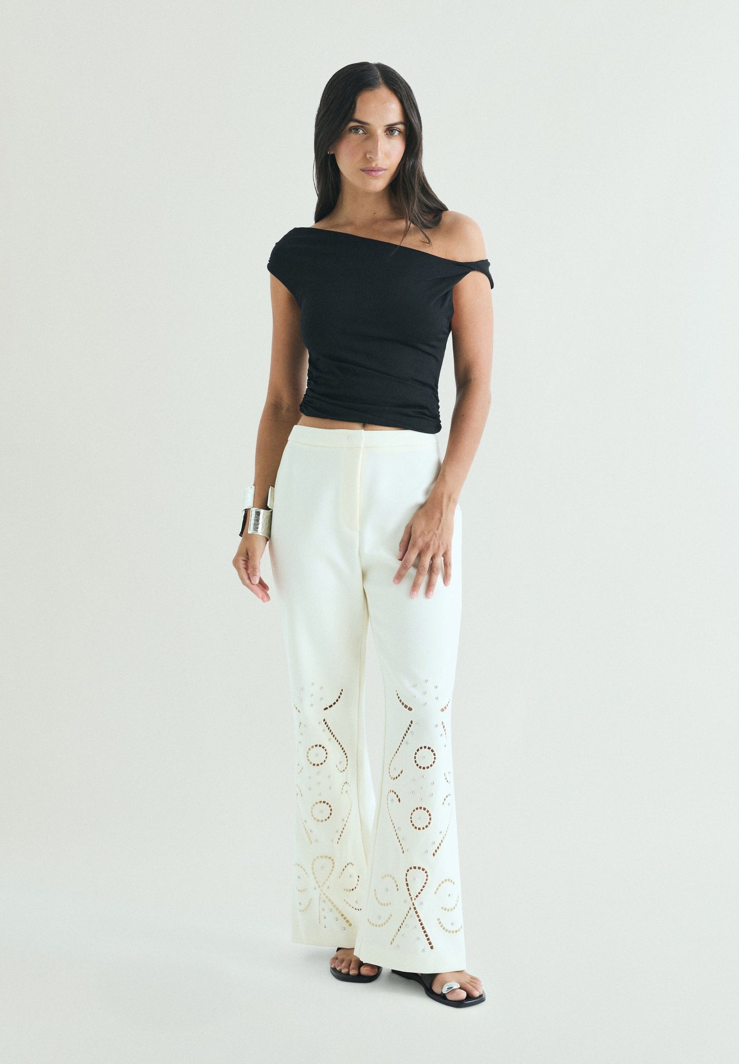 TROUSERS WITH PERFORATED DETAILS