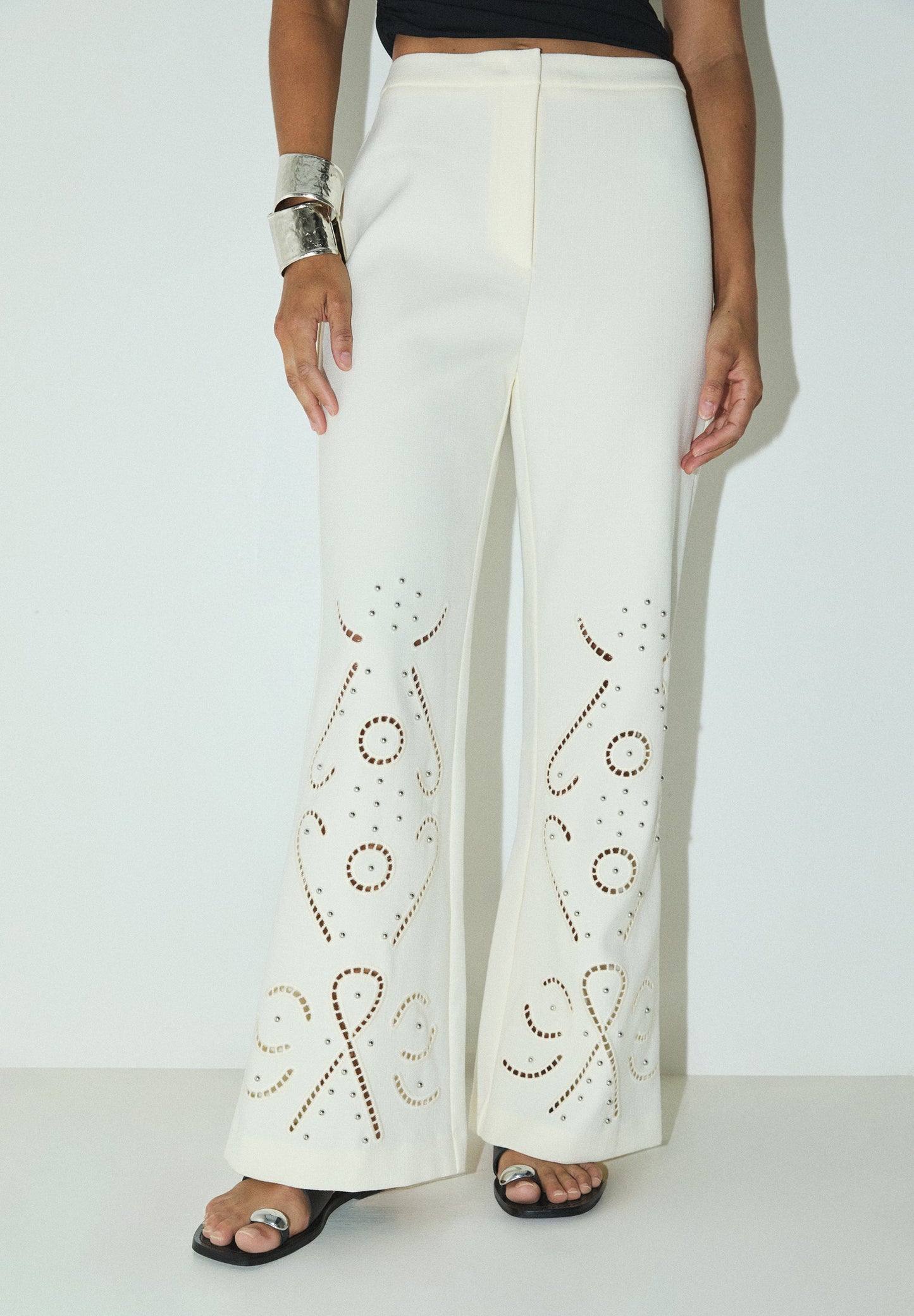 TROUSERS WITH PERFORATED DETAILS